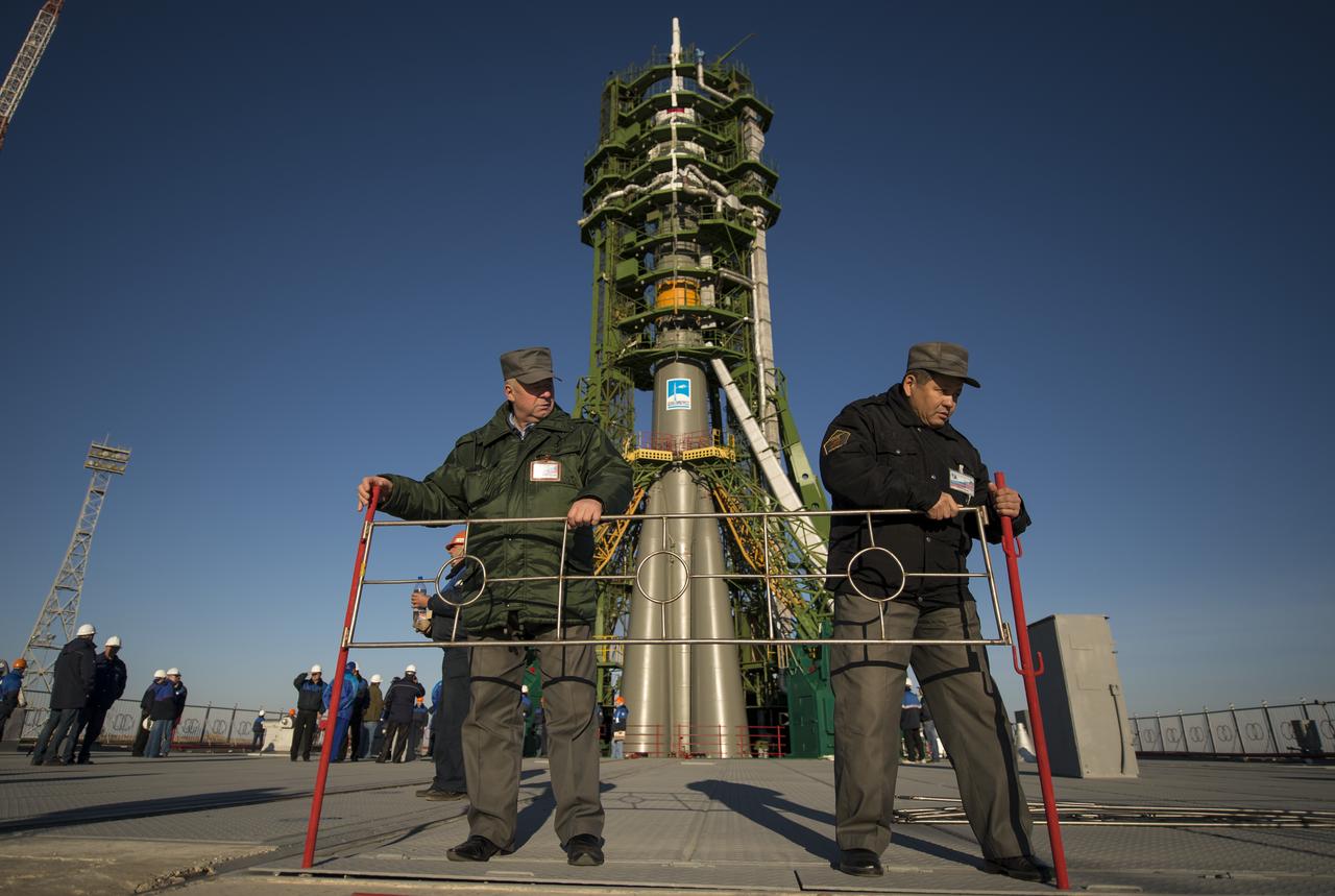 Pad workers install a safety railing at the launch pad shortly after the Soyuz rocket is erected into position, on Sunday, October 21, 2012, at the Baikonur Cosmodrome in Kazakhstan.  Launch of the Soyuz rocket is scheduled for October 23 and will send Expedition 33/34 Flight Engineer Kevin Ford of NASA, Soyuz Commander Oleg Novitskiy and Flight Engineer Evgeny Tarelkin of ROSCOSMOS on a five-month mission aboard the International Space Station.  Photo Credit: (NASA/Bill Ingalls)