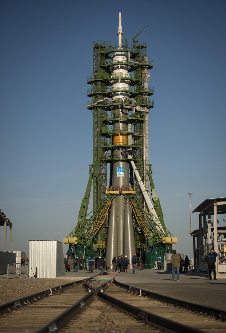 The Soyuz rocket is erected into position after being rolled out to the launch pad by train, on Sunday, October 21, 2012, at the Baikonur Cosmodrome in Kazakhstan.  Launch of the Soyuz rocket is scheduled for October 23 and will send Expedition 33/34 Flight Engineer Kevin Ford of NASA, Soyuz Commander Oleg Novitskiy and Flight Engineer Evgeny Tarelkin of ROSCOSMOS on a five-month mission aboard the International Space Station.  Photo Credit: (NASA/Bill Ingalls)