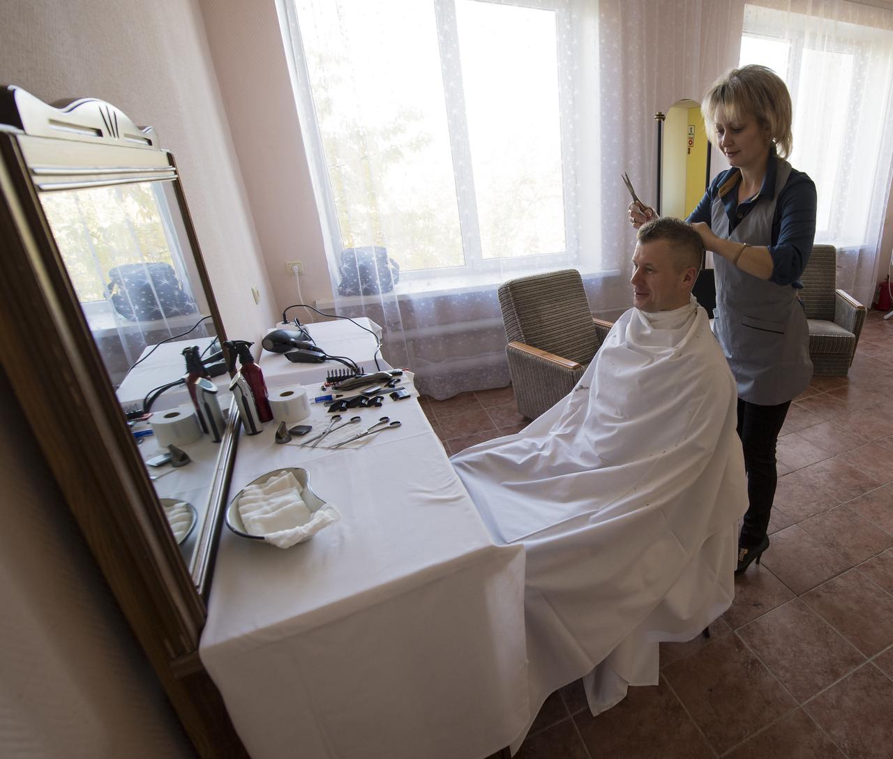 Expedition 33 Soyuz Commander Oleg Novitskiy gets his hair cut at the Cosmonaut Hotel, on Sunday, October 21, 2012, at the Baikonur Cosmodrome in Kazakhstan. Launch of the Soyuz rocket is scheduled for October 23 and will send Expedition 33/34 Flight Engineer Kevin Ford of NASA, Soyuz Commander Oleg Novitskiy and Flight Engineer Evgeny Tarelkin of ROSCOSMOS on a five-month mission aboard the International Space Station. Photo Credit: (NASA/Bill Ingalls)