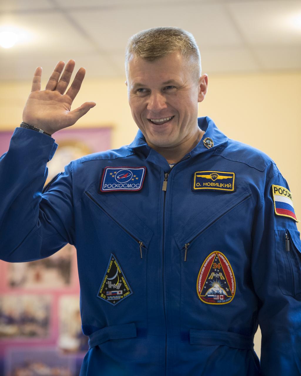 Expedition 33 Soyuz Commander Oleg Novitskiy waves hello as he is introduced at the start of a press conference held at the Cosmonaut Hotel, on Monday, October 22, 2012, in Baikonur, Kazakhstan. Launch of the Soyuz rocket is scheduled for October 23 and will send Expedition 33/34 Flight Engineer Kevin Ford of NASA, Soyuz Commander Oleg Novitskiy and Flight Engineer Evgeny Tarelkin of ROSCOSMOS on a five-month mission aboard the International Space Station. Photo Credit: (NASA/Bill Ingalls)