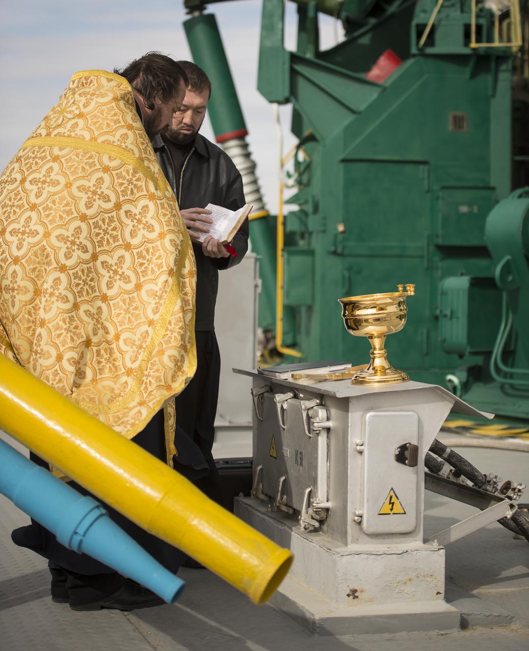 An Orthodox priest blesses the Soyuz rocket at the Baikonur Cosmodrome Launch pad on Monday, Oct. 22, 2012 in Baikonur, Kazakhstan. Launch of the Soyuz rocket is scheduled for October 23 and will send Expedition 33/34 Flight Engineer Kevin Ford of NASA, Soyuz Commander Oleg Novitskiy and Flight Engineer Evgeny Tarelkin of ROSCOSMOS on a five-month mission aboard the International Space Station. Photo Credit: (NASA/Bill Ingalls)