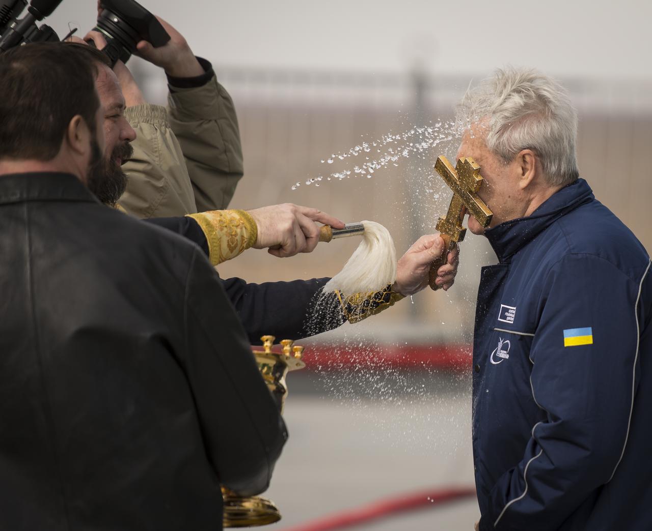 An Orthodox priest blesses a worker near the Soyuz rocket at the Baikonur Cosmodrome Launch pad on Monday, Oct. 22, 2012 in Baikonur, Kazakhstan. Launch of the Soyuz rocket is scheduled for October 23 and will send Expedition 33/34 Flight Engineer Kevin Ford of NASA, Soyuz Commander Oleg Novitskiy and Flight Engineer Evgeny Tarelkin of ROSCOSMOS on a five-month mission aboard the International Space Station. Photo Credit: (NASA/Bill Ingalls)