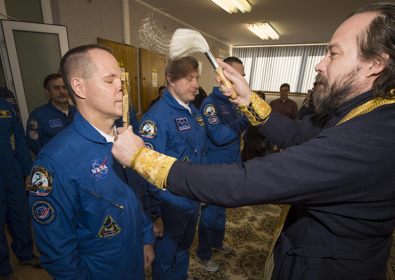 Expedition 33/34 crew members, Flight Engineer Kevin Ford of NASA, left, Soyuz Commander Oleg Novitskiy, and Flight Engineer Evgeny Tarelkin of ROSCOSMOS, right, receive the traditional blessing from a Russian Orthodox priest at the Cosmonaut Hotel on the morning of their Soyuz launch to the International Space Station on Tuesday, October 23, 2012, in Baikonur, Kazakhstan. Launch of a Soyuz rocket later in the afternoon will send Ford, Novitskiy and Tarelkin on a five-month mission aboard the International Space Station.  Photo Credit: (NASA/Bill Ingalls)