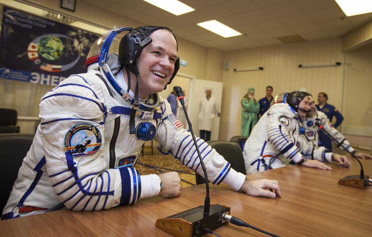 Expedition 33/34 crew members, NASA Astronaut and Flight Engineer Kevin Ford, left, Russian Cosmonaut and Soyuz Commander Oleg Novitskiy, and Russian Cosmonaut and Flight Engineer Evgeny Tarelkin, far right, talk to family members through glass from the room where they just had their Russian Sokol suits pressure checked ahead of their launch onboard a Soyuz TMA-06M spacecraft to the International Space Station, Tuesday, October 23, 2012, in Baikonur, Kazakhstan. Launch of the Soyuz rocket will send Ford, Novitskiy and Tarelkin on a five-month mission aboard the International Space Station.  Photo Credit: (NASA/GCTC/Andrey Shelepin)