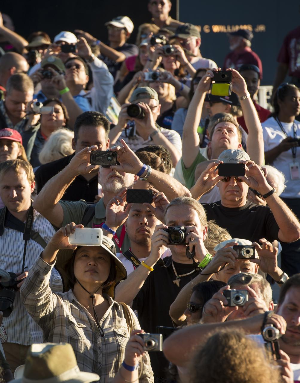Onlookers watch as space shuttle Atlantis rolls to its new home at the Kennedy Space Center Visitor Complex, early Friday, Nov. 2, 2012, in Cape Canaveral, Fla.  The spacecraft traveled 125,935,769 miles during 33 spaceflights, including 12 missions to the International Space Station. Its final flight, STS-135, closed out the Space Shuttle Program era with a landing on July 21, 2011. Photo Credit: (NASA/Bill Ingalls)