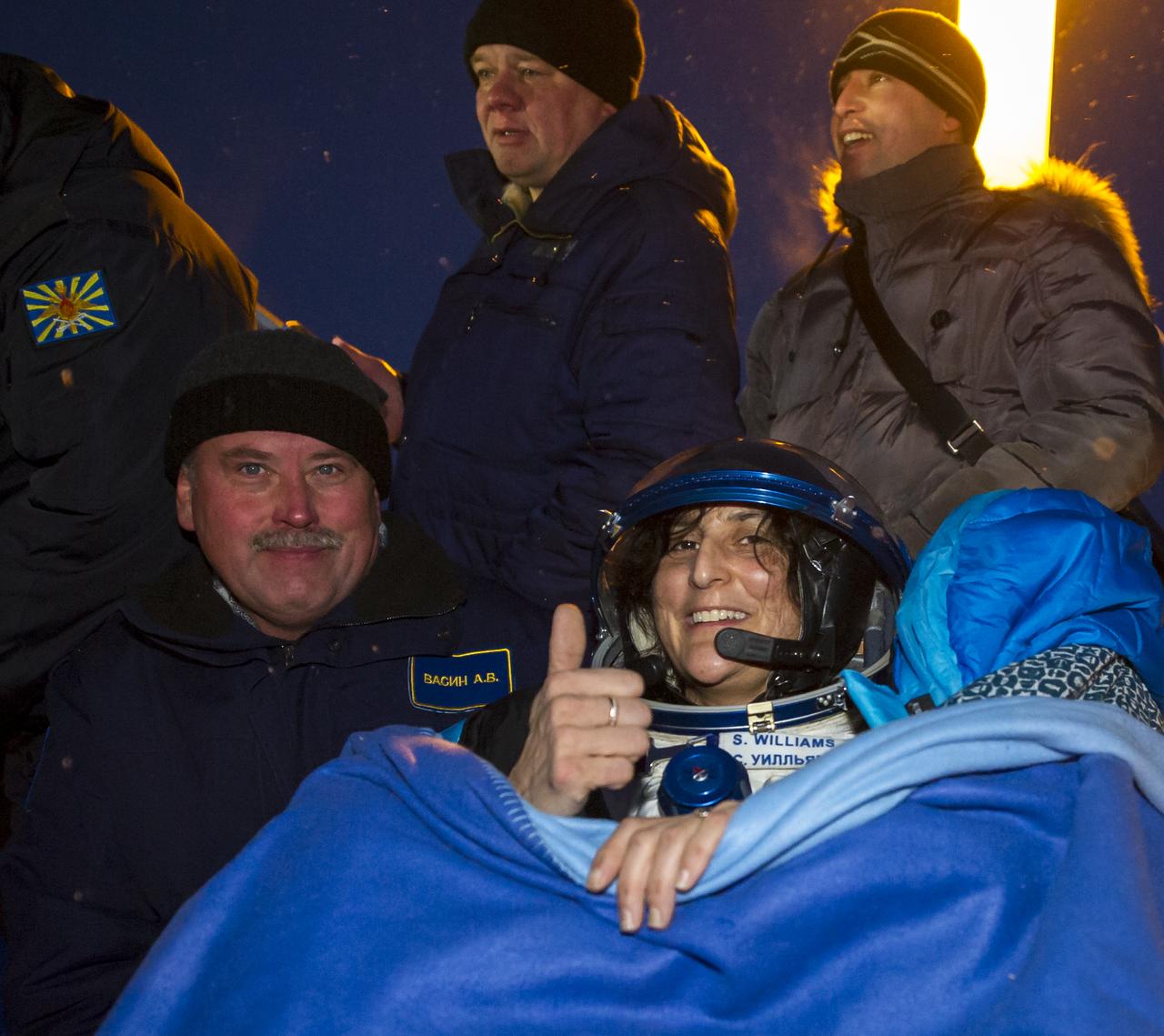 Expedition 33 Commander Sunita Williams of NASA smiles and gives a thumbs up in a chair outside the Soyuz Capsule after she and Flight Engineers Yuri Malenchenko of ROSCOSMOS (Russian Federal Space Agency), and Akihiko Hoshide of JAXA (Japan Aerospace Exploration Agency), landed their Soyuz spacecraft in a remote area outside the town of Arkalyk, Kazakhstan, on Monday, Nov. 19, 2012. Williams, Hoshide and Malenchenko returned from four months onboard the International Space Station. Photo Credit: (NASA/GCTC/Andrey Shelepin)