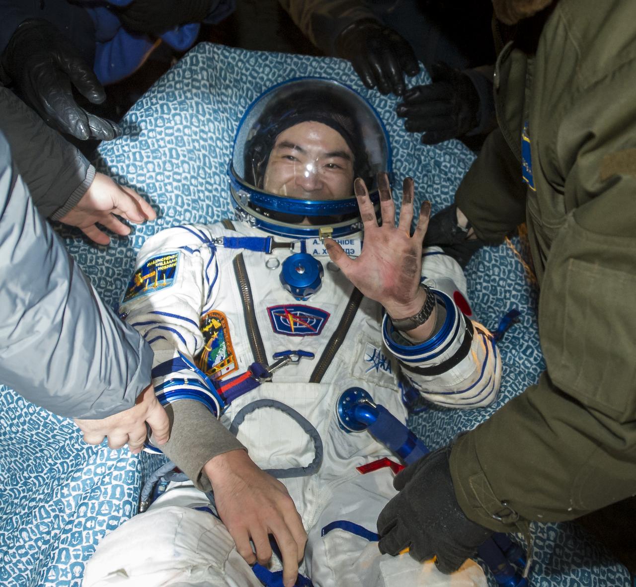 Expedition 33 Flight Engineer Akihiko Hoshide of JAXA (Japan Aerospace Exploration Agency) waves hello in a chair outside the Soyuz Capsule after he and Commander Sunita Williams of NASA, and Flight Engineer Yuri Malenchenko of ROSCOSMOS (Russian Federal Space Agency), landed their Soyuz spacecraft in a remote area outside the town of Arkalyk, Kazakhstan, on Monday, Nov. 19, 2012. Williams, Hoshide and Malenchenko returned from four months onboard the International Space Station. Photo Credit: (NASA/GCTC/Andrey Shelepin)