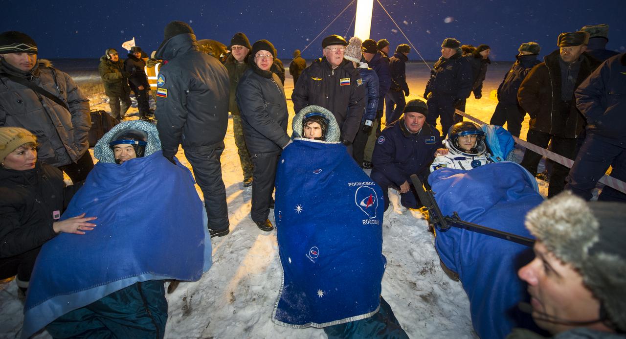 Expedition 33 Commander Sunita Williams of NASA, right, and Flight Engineers Yuri Malenchenko of ROSCOSMOS (Russian Federal Space Agency), and Akihiko Hoshide of JAXA (Japan Aerospace Exploration Agency), left, sit in chairs outside the Soyuz Capsule just minutes after they landed in a remote area outside the town of Arkalyk, Kazakhstan, on Monday, Nov. 19, 2012. Williams, Hoshide and Malenchenko returned from four months onboard the International Space Station. Photo Credit: (NASA/GCTC/Andrey Shelepin)
