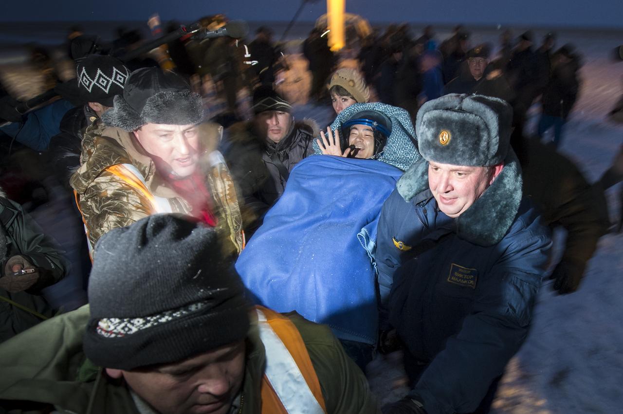 Expedition 33 Flight Engineer Akihiko Hoshide of JAXA (Japan Aerospace Exploration Agency) is carried to a medical tent shortly after he and Commander Sunita Williams of NASA, and Flight Engineer Yuri Malenchenko of ROSCOSMOS (Russian Federal Space Agency), landed their Soyuz spacecraft in a remote area outside the town of Arkalyk, Kazakhstan, on Monday, Nov. 19, 2012. Williams, Hoshide and Malenchenko returned from four months onboard the International Space Station. Photo Credit: (NASA/Bill Ingalls)