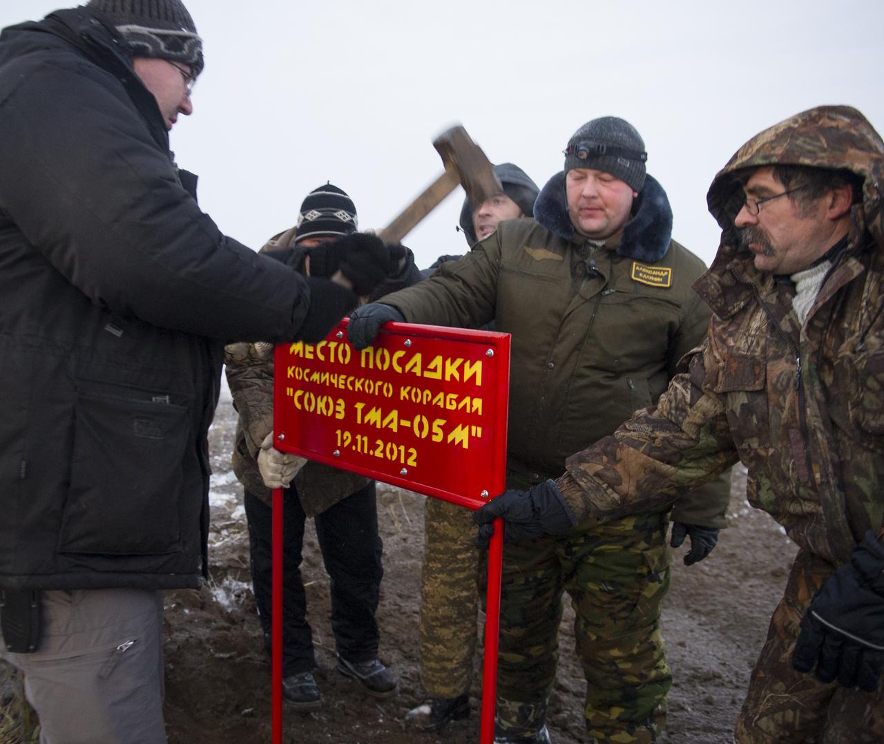 Workers place a marker where the Soyuz TMA-05M spacecraft landed with Expedition 33 Commander Sunita Williams of NASA and Flight Engineers Akihiko Hoshide of JAXA (Japan Aerospace Exploration Agency), and Yuri Malenchenko of ROSCOSMOS (Russian Federal Space Agency) in a remote area near the town of Arkalyk, Kazakhstan, on Monday, Nov. 19, 2012. Williams, Hoshide and Malenchenko returned from four months onboard the International Space Station. Photo Credit: (NASA/GCTC/Andrey Shelepin)
