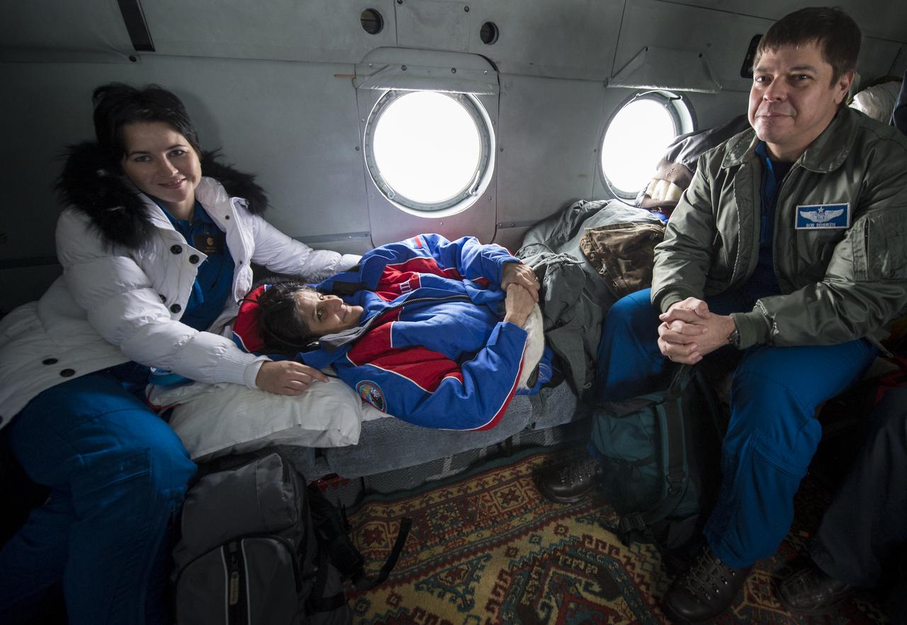 Expedition 33 Commander Sunita Williams of NASA rests during a helicopter flight back to Kustanany, Kazakhstan while nurse Raxana Batsmanova and Chief of the NASA Astronaut Office Bob Behnken look on just a a few hours after Williams and Flight Engineers Yuri Malenchenko of ROSCOSMOS (Russian Federal Space Agency), and Akihiko Hoshide of JAXA (Japan Aerospace Exploration Agency), landed their Soyuz spacecraft in a remote area outside the town of Arkalyk, Kazakhstan, on Monday, Nov. 19, 2012. Williams, Hoshide and Malenchenko returned from four months onboard the International Space Station. Photo Credit: (NASA/Bill Ingalls)