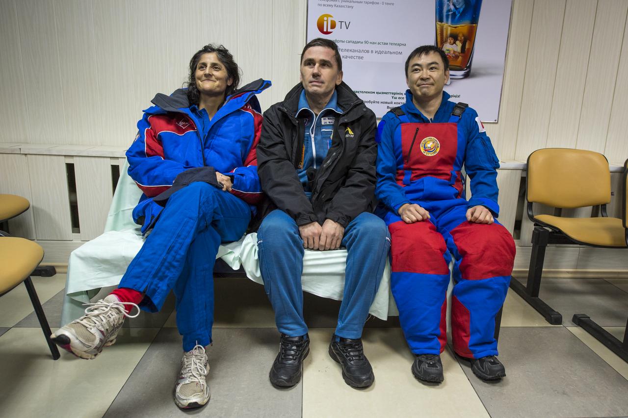 Expedition 33 crew members; Commander Sunita Williams of NASA, left, Flight Engineers Yuri Malenchenko of ROSCOSMOS (Russian Federal Space Agency), and Akihiko Hoshide of JAXA (Japan Aerospace Exploration Agency), right, smile for photos at the Kustanay Airport in Kazakhstan a few hours after they landed their Soyuz spacecraft in a remote area outside the town of Arkalyk, Kazakhstan, on Monday, Nov. 19, 2012. Williams, Hoshide and Malenchenko returned from four months onboard the International Space Station. Photo Credit: (NASA/Bill Ingalls)
