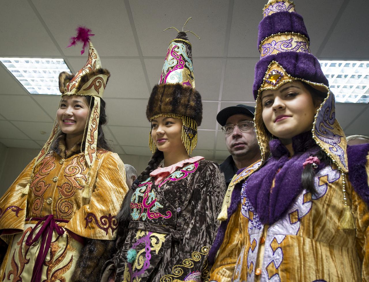 Girls in traditional Kazakh dress smile after welcoming home Expedition 33 crew members; Commander Sunita Williams of NASA, and Flight Engineers Yuri Malenchenko of ROSCOSMOS (Russian Federal Space Agency), and Akihiko Hoshide of JAXA (Japan Aerospace Exploration Agency) at the Kustanay Airport in Kazakhstan a few hours after the Expedition 33 crew landed their Soyuz spacecraft in a remote area outside the town of Arkalyk, Kazakhstan, on Monday, Nov. 19, 2012. Williams, Hoshide and Malenchenko returned from four months onboard the International Space Station. Photo Credit: (NASA/Bill Ingalls)