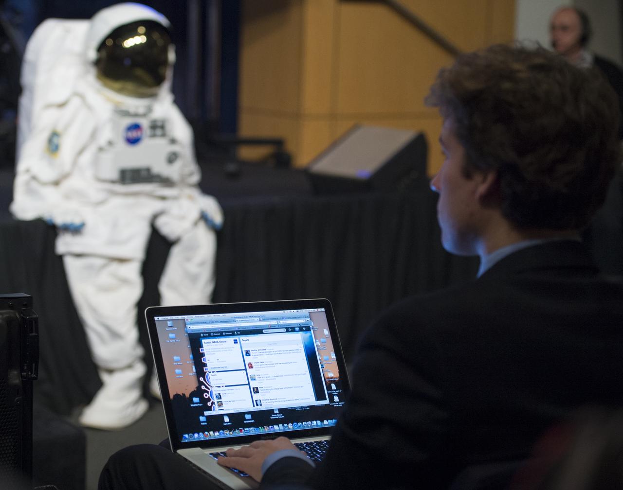 A participant at a NASA Social in Washington tweets as he listens to astronaut Joe Acaba answer questions about his time living aboard the International Space Station, Tuesday, Dec. 4, 2012 at NASA Headquarters. NASA astronaut Joe Acaba launched to the ISS on a Russian Soyuz spacecraft May 15, 2012, spending 123 days aboard as a flight engineer of the Expedition 31 and 32 crews. He recently returned to Earth on Sept. 17 after four months in low earth orbit. Photo Credit: (NASA/Carla Cioffi)