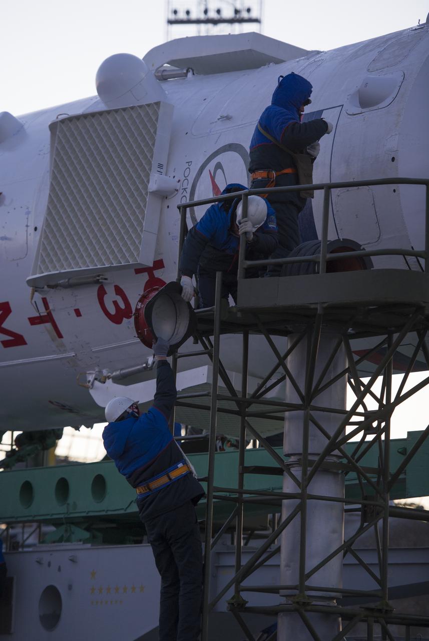 Technicians prepare the Soyuz rocket to be erected at the launch pad shortly after it arrived by train on Monday, December 17, 2012, at the Baikonur Cosmodrome in Kazakhstan.  Launch of the Soyuz rocket is scheduled for December 19 and will send Expedition 34/35 Flight Engineer Tom Marshburn of NASA, Soyuz Commander Roman Romanenko and Expedition 35 Commander Chris Hadfield of the Canadian Space Agency (CSA) on a five-month mission aboard the International Space Station.  Photo Credit: (NASA/Carla Cioffi)