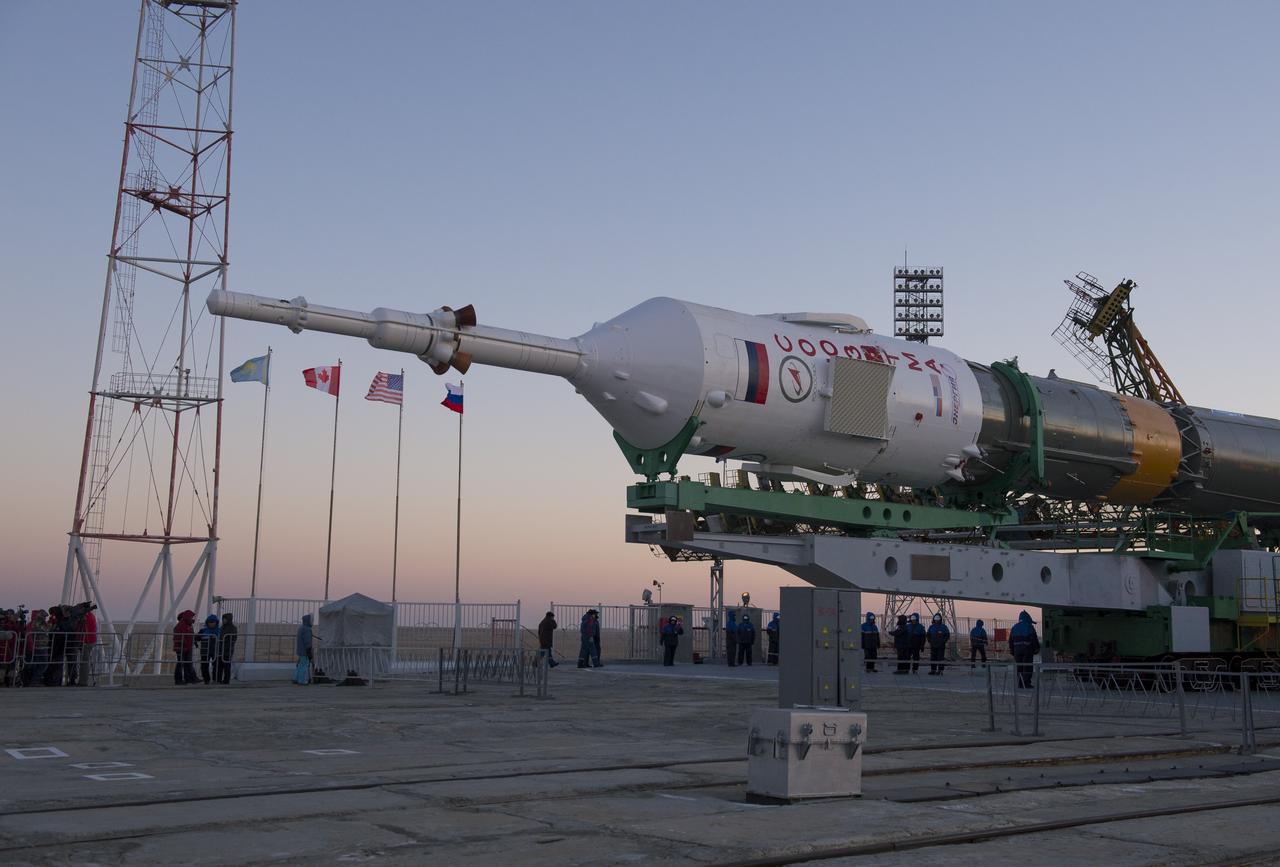 The Soyuz rocket is erected into position after being rolled out to the launch pad by train on Monday, December 17, 2012, at the Baikonur Cosmodrome in Kazakhstan.  Launch of the Soyuz rocket is scheduled for December 19 and will send Expedition 34/35 Flight Engineer Tom Marshburn of NASA, Soyuz Commander Roman Romanenko and Expedition 35 Commander Chris Hadfield of the Canadian Space Agency (CSA) on a five-month mission aboard the International Space Station.  Photo Credit: (NASA/Carla Cioffi).  Photo Credit: (NASA/Carla Cioffi)