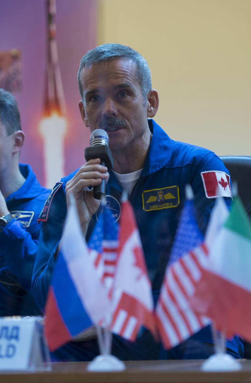 Expedition 34/35 Flight Engineer and Expedition 35 Commander Chris Hadfield of the Canadian Space Agency (CSA) answers a reporter's question at a press conference held at the Cosmonaut Hotel, on Tuesday, Dec. 18, 2012, in Baikonur, Kazakhstan. Launch of the Soyuz rocket is scheduled for December 19 and will send Hadfield, Tom Marshburn of NASA and Roman Romanenko of ROSCOSMOS on a five-month mission aboard the International Space Station.  Photo Credit: (NASA/Carla Cioffi)