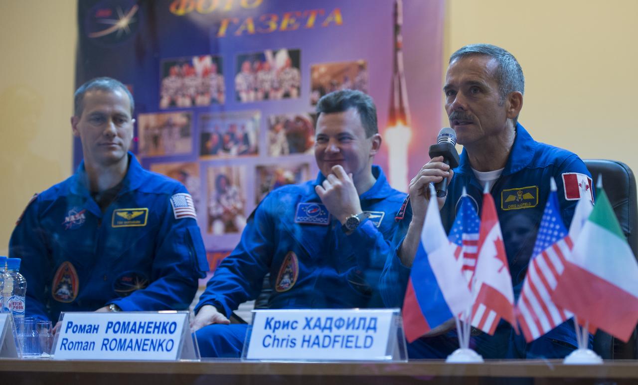 Expedition 34/35 Flight Engineer Tom Marshburn of NASA, left, Soyuz Commander Roman Romanenko and Canadian Space Agency (CSA) Flight Engineer Chris Hadfield, right, are seen during a press conference held at the Cosmonaut Hotel, on Tuesday, Dec. 18, 2012, in Baikonur, Kazakhstan. Launch of the Soyuz rocket is scheduled for December 19 and will send Marshburn, Romanenko and Hadfield on a five-month mission aboard the International Space Station. Photo Credit: (NASA/Carla Cioffi)