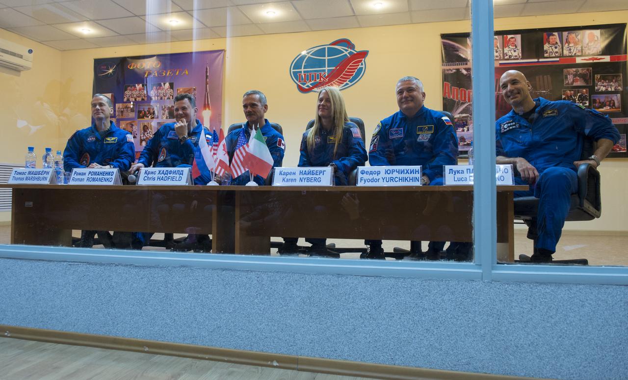 Expedition 34/35 prime crew members from left: Flight Engineer Tom Marshburn of NASA, Soyuz Commander Roman Romanenko, Flight Engineer Chris Hadfield of the Canadian Space Agency (CSA), and backup crew members NASA astronaut Karen Nyber, Russian cosmonaut Fyodor Yurchikin, and European Space Agency astronaut Luca Parmitano are seen during a press conference held at the Cosmonaut Hotel, on Tuesday, December 18, 2012, in Baikonur, Kazakhstan.  Photo Credit: (NASA/Carla Cioffi)