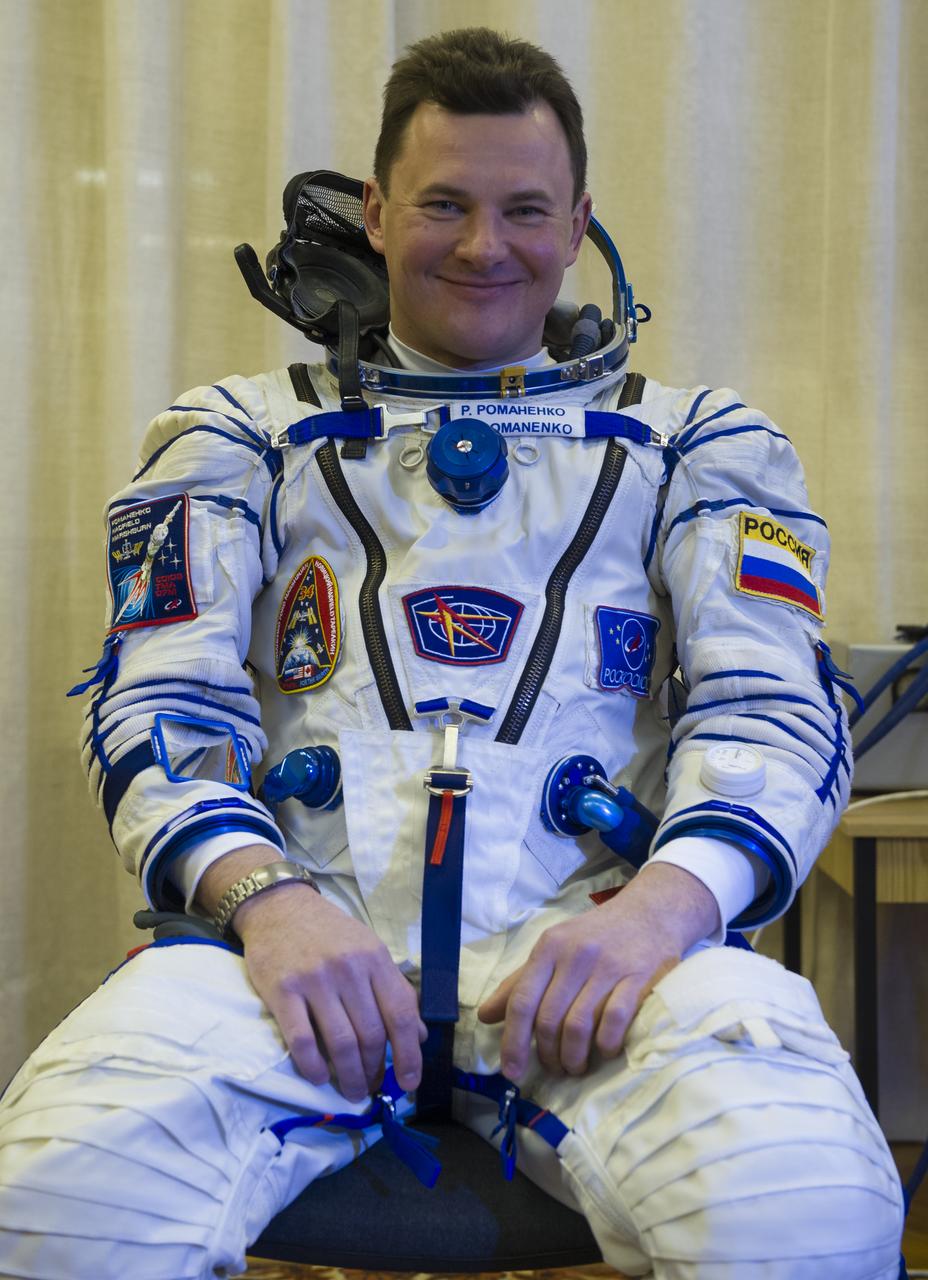 Expedition 34/35 Soyuz Commander Roman Romanenko is helped into his Russian Sokol suit as he and fellow cremates, Flight Engineer Tom Marshburn and Flight Engineer Chris Hadfield prepare for their Soyuz launch to the International Space Station, on Wednesday, Dec. 19, 2012, in Baikonur, Kazakhstan. Launch of the Soyuz rocket will send Romanenko, Marshburn and Hadfield on a five-month mission aboard the International Space Station.  Photo Credit: (NASA/GCTC/Andrey Shelepin)