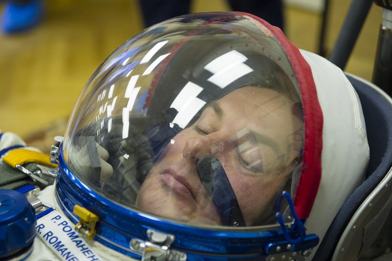Expedition 34/35 Soyuz Commander Roman Romanenko  has his Russian Sokol suit pressure checked ahead of his launch onboard a Soyuz TMA-07M spacecraft to the International Space Station with fellow cremates, Flight Engineers Chris Hadfield and Tom Marshburn, on Wednesday, Dec. 19, 2012, in Baikonur, Kazakhstan. Launch of the Soyuz rocket will send Romanenko, Marshburn and Hadfield on a five-month mission aboard the International Space Station.  Photo Credit: (NASA/GCTC/Andrey Shelepin)