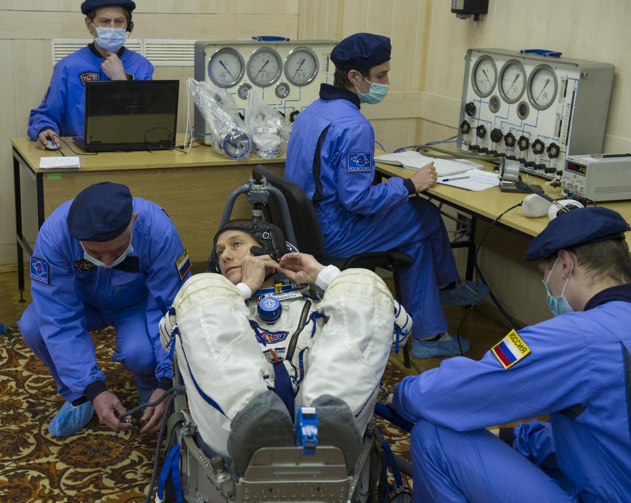 Expedition 34/35 Flight Engineer Tom Marshburn has his Russian Sokol suit pressure checked ahead of his launch onboard a Soyuz TMA-07M spacecraft to the International Space Station with fellow cremates, Flight Engineer Chris Hadfield and Soyuz Commander Roman Romanenko, on Wednesday, Dec. 19, 2012, in Baikonur, Kazakhstan. Launch of the Soyuz rocket will send Marshburn, Romanenko and Hadfield on a five-month mission aboard the International Space Station. Photo Credit: (NASA/GCTC/Andrey Shelepin)