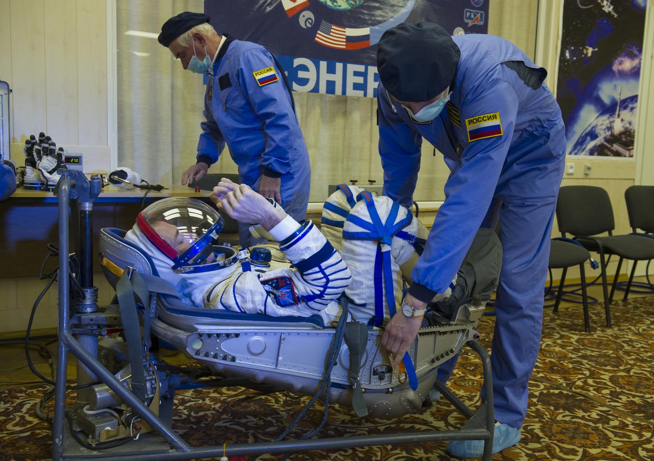 Expedition 34/35 Flight Engineer Chris Hadfield has his Russian Sokol suit pressure checked ahead of his launch onboard a Soyuz TMA-07M spacecraft to the International Space Station with fellow cremates, Flight Engineer Tom Marshburn and Soyuz Commander Roman Romanenko, on Wednesday, Dec. 19, 2012, in Baikonur, Kazakhstan. Launch of the Soyuz rocket will send Hadfield, Romanenko and Marshburn on a five-month mission aboard the International Space Station.  Photo Credit: (NASA/GCTC/Andrey Shelepin)