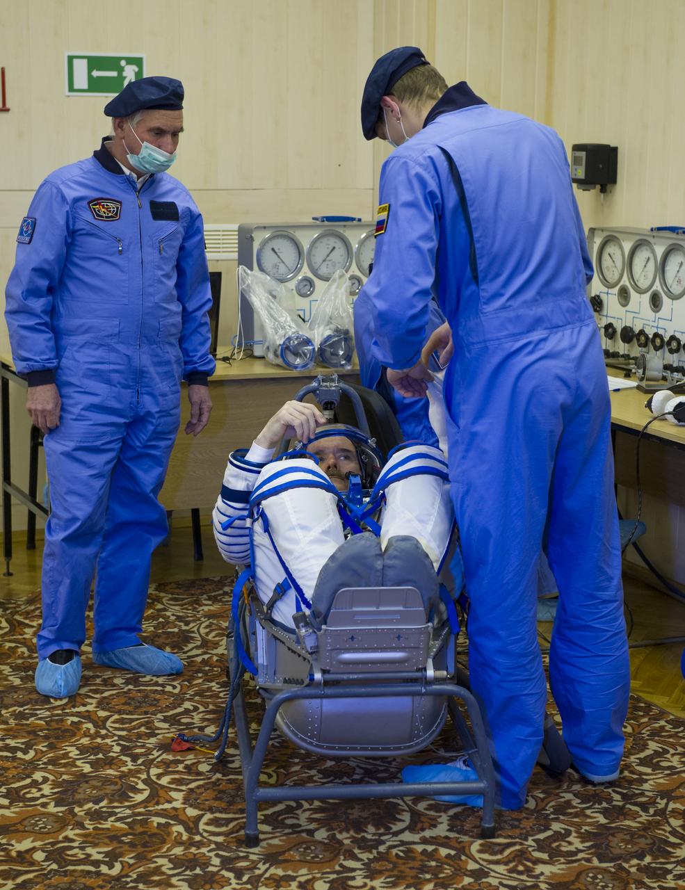 Expedition 34/35 Flight Engineer Chris Hadfield has his Russian Sokol suit pressure checked ahead of his launch onboard a Soyuz TMA-07M spacecraft to the International Space Station with fellow cremates, Flight Engineer Tom Marshburn and Soyuz Commander Roman Romanenko, on Wednesday, Dec. 19, 2012, in Baikonur, Kazakhstan. Launch of the Soyuz rocket will send Hadfield, Romanenko and Marshburn on a five-month mission aboard the International Space Station.  Photo Credit: (NASA/GCTC/Andrey Shelepin)