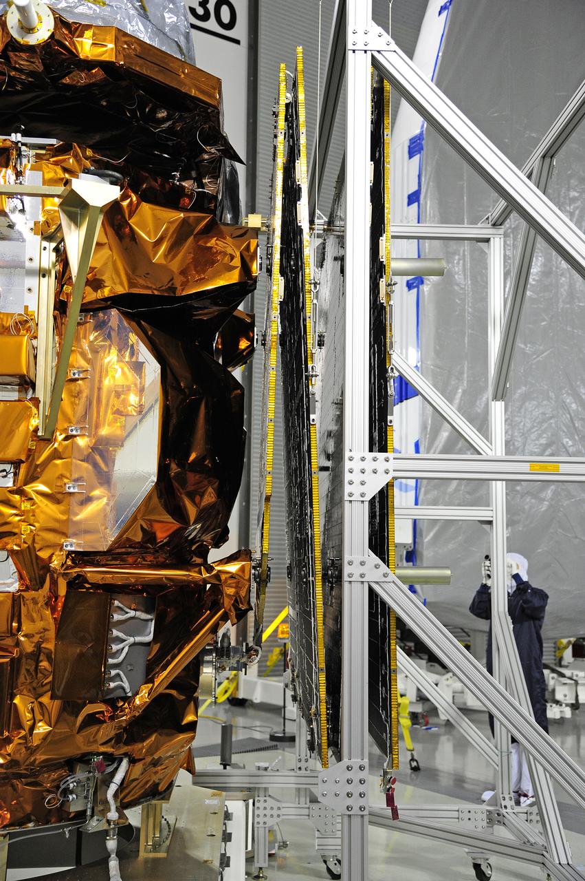 VANDENBERG AFB, Calif. -- In the Astrotech processing facility at Vandenberg Air Force Base, Calif., a technician photographs NASA's Landsat Data Continuity Mission, or LDCM, satellite after the solar arrays were attached and tested.   The Landsat Data Continuity Mission LDCM is the future of Landsat satellites. It will continue to obtain valuable data and imagery to be used in agriculture, education, business, science, and government. The Landsat Program provides repetitive acquisition of high resolution multispectral data of the Earth's surface on a global basis. The data from the Landsat spacecraft constitute the longest record of the Earth's continental surfaces as seen from space. It is a record unmatched in quality, detail, coverage, and value. Liftoff is planned for Feb. 11, 2013 aboard a United Launch Alliance Atlas V rocket. For more information, visit: http:__www.nasa.gov_mission_pages_landsat_main_index.html Photo credit: NASA