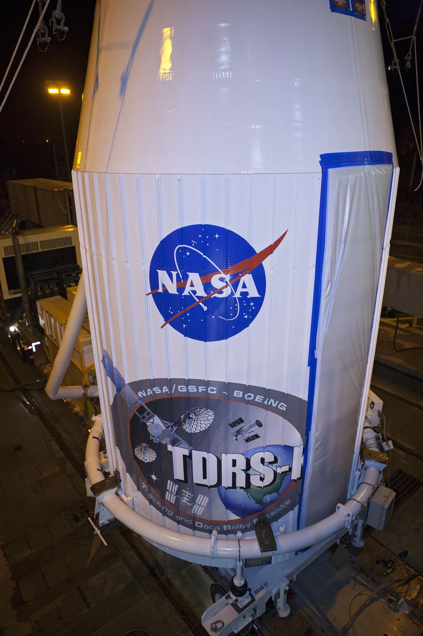 CAPE CANAVERAL, Fla. –- Enclosed in its payload fairing, NASA's Tracking and Data Relay Satellite, TDRS-K, is being prepare for the lift that will place it atop a United Launch Alliance Atlas V rocket at Cape Canaveral Air Force Station's Space Launch Complex 41. Liftoff for the TDRS-K is planned for January 30, 2013. The TDRS-K spacecraft is part of the next-generation series in the Tracking and Data Relay Satellite System, a constellation of space-based communication satellites providing tracking, telemetry, command and high-bandwidth data return services. For more information, visit http:__www.nasa.gov_mission_pages_tdrs_index.html Photo credit: NASA_ Glenn Bension