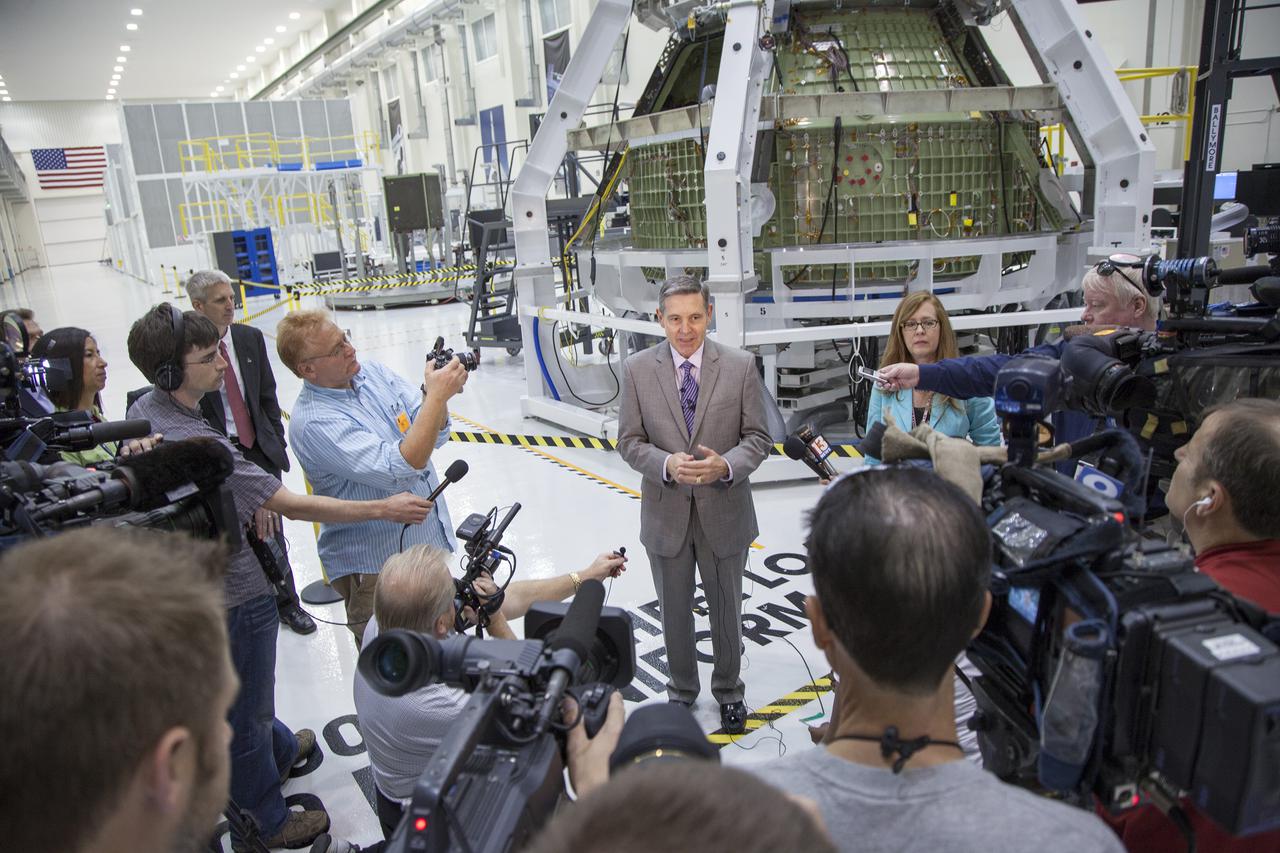 CAPE CANAVERAL, Fla. – Inside the high bay of Kennedy Space Center's Operations and Checkout Building, Kennedy Director Bob Cabana, provided members of the news media a status on the center's transformation to a multiuse government and commercial space launch and recovery complex. In the background, the Orion spacecraft is surrounded by a special pre-launch processing access fixture.   Orion is the exploration spacecraft designed to carry crews to space beyond low Earth orbit. It will provide emergency abort capability, sustain the crew during the space travel and provide safe re-entry from deep space return velocities. The first unpiloted test flight of the Orion is scheduled to launch in 2014 atop a Delta IV rocket and in 2017 on a Space Launch System rocket. For more information, visit http:__www.nasa.gov_orion Photo credit: NASA_Kim Shiflett