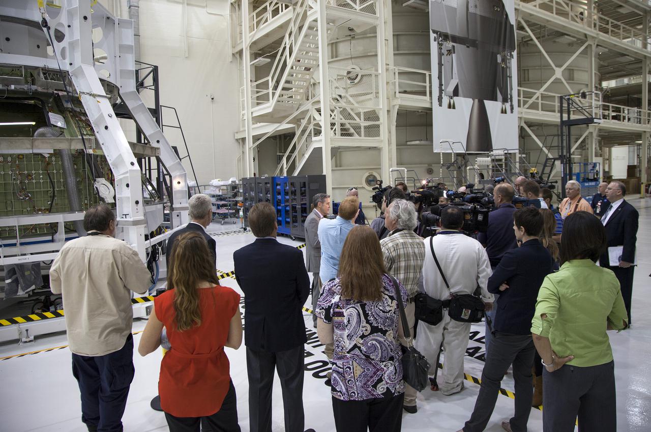 CAPE CANAVERAL, Fla. – Inside the high bay of Kennedy Space Center's Operations and Checkout Building, Kennedy Director Bob Cabana, provided members of the news media a status on the center's transformation to a multiuse government and commercial space launch and recovery complex. In the background, the Orion spacecraft is surrounded by a special pre-launch processing access fixture.   Orion is the exploration spacecraft designed to carry crews to space beyond low Earth orbit. It will provide emergency abort capability, sustain the crew during the space travel and provide safe re-entry from deep space return velocities. The first unpiloted test flight of the Orion is scheduled to launch in 2014 atop a Delta IV rocket and in 2017 on a Space Launch System rocket. For more information, visit http:__www.nasa.gov_orion Photo credit: NASA_Kim Shiflett