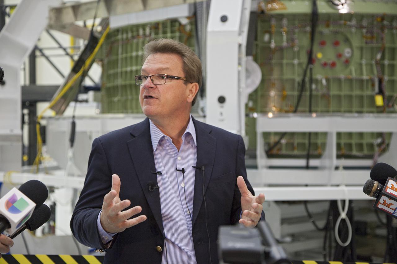 CAPE CANAVERAL, Fla. – Inside the high bay of Kennedy Space Center's Operations and Checkout Building, Jules Schnieder, Lockheed Martin's Orion production manager at the Florida Spaceport, briefs members of the news media about progress in preparing Orion for its first flight. In the background, the Orion spacecraft is surrounded by a special pre-launch processing access fixture. Lockheed Martin is NASA's prime contractor for the Orion spacecraft.   Orion is the exploration spacecraft designed to carry crews to space beyond low Earth orbit. It will provide emergency abort capability, sustain the crew during the space travel and provide safe re-entry from deep space return velocities. The first unpiloted test flight of the Orion is scheduled to launch in 2014 atop a Delta IV rocket and in 2017 on a Space Launch System rocket. For more information, visit http:__www.nasa.gov_orion Photo credit: NASA_Kim Shiflett