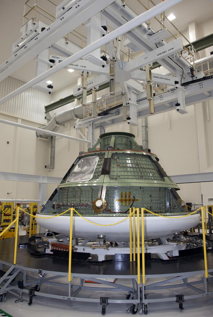 CAPE CANAVERAL, Fla. -- The Orion Ground Test Vehicle is on display in the high bay of the Operations and Checkout Building at NASA's Kennedy Space Center in Florida during a tour for media representatives.  Orion is the exploration spacecraft designed to carry crews to space beyond low-Earth orbit. It will provide emergency abort capability, sustain the crew during the space travel and provide safe re-entry from deep space return velocities. The first unpiloted test flight of the Orion is scheduled in 2014 atop a Delta IV rocket, and in 2017, on a Space Launch System rocket. For more information, visit http:__www.nasa.gov_orion.  Photo credit: NASA_Frankie Martin