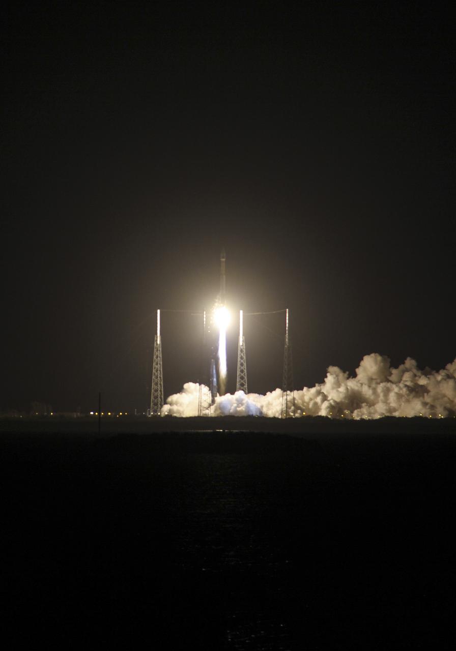 CAPE CANAVERAL, Fla. -- Plumes of exhaust and smoke billow around the lightning masts on Space Launch Complex 41 on Cape Canaveral Air Force Station in Florida as a United Launch Alliance Atlas V 401 rocket lifts off at 8:48 p.m. EST, carrying NASA's Tracking and Data Relay Satellite-K, TDRS-K,  to orbit.  The TDRS-K spacecraft is part of the next-generation series in the Tracking and Data Relay Satellite System, a constellation of space-based communication satellites providing tracking, telemetry, command and high-bandwidth data return services. For more information, visit http:__www.nasa.gov_mission_pages_tdrs_index.html.  Photo credit: NASA_Scott Neener and Cory Huston