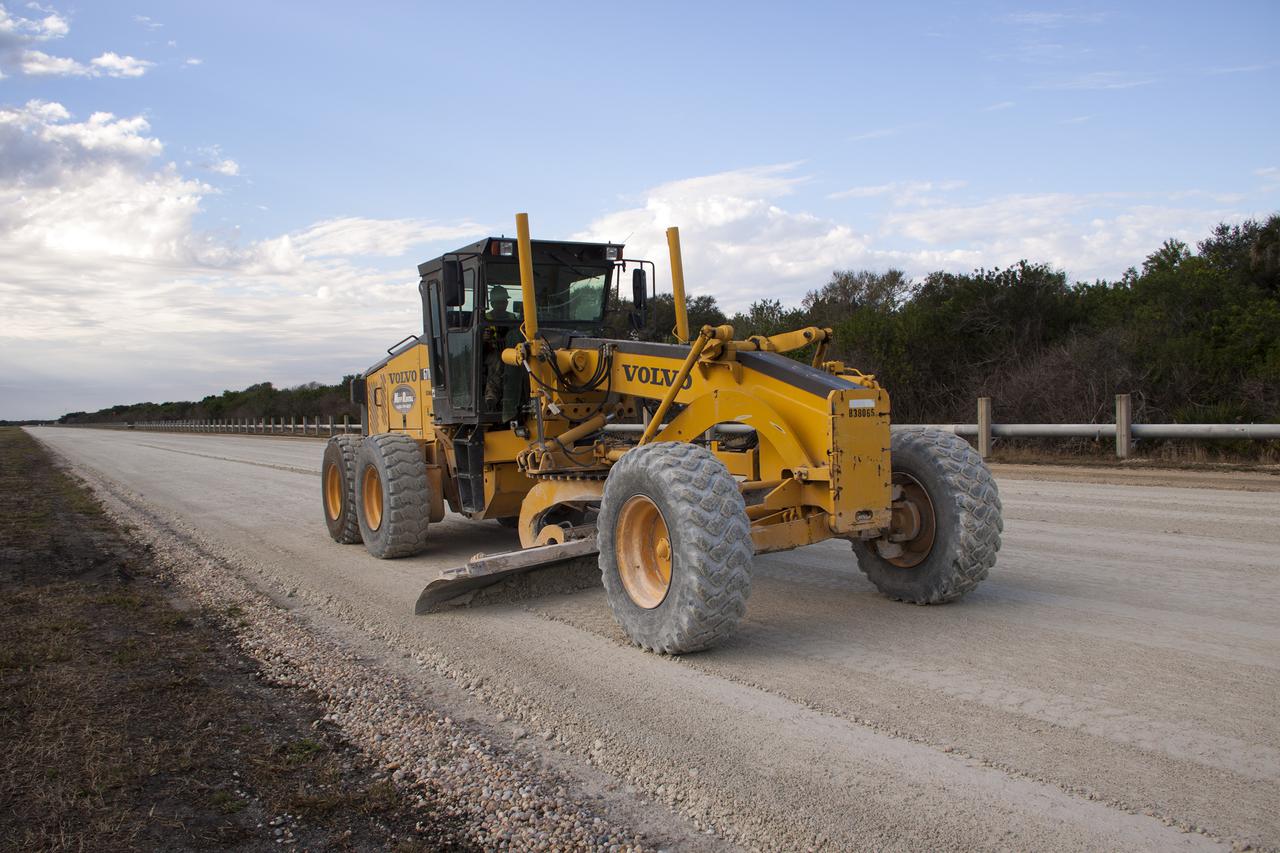 CAPE CANAVERAL, Fla. – A worker from Canaveral Construction in Mims, Fla., re-grades a section of the crawlerway near Launch Pad 39B at NASA’s Kennedy Space Center in Florida.  The crawlerway is being upgraded to improve the foundation and prepare it to support the weight of NASA’s Space Launch System, or SLS, and mobile launcher on the crawler-transporter during rollout. Workers are removing the original Alabama river rock and restoring the layer of lime rock below to its original depth of three feet. Then new river rock will be added on top. The Ground Systems Development and Operations, or GSDO, Program office at Kennedy is leading the center’s transformation to safely handle a variety of rockets and spacecraft. For more information about GSDO, visit: http:__go.nasa.gov_groundsystems.  Photo credit: NASA_Jim Grossmann