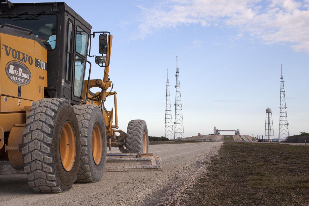 CAPE CANAVERAL, Fla. – A worker from Canaveral Construction in Mims, Fla., re-grades a section of the crawlerway near Launch Pad 39B at NASA’s Kennedy Space Center in Florida.  The crawlerway is being upgraded to improve the foundation and prepare it to support the weight of NASA’s Space Launch System, or SLS, and mobile launcher on the crawler-transporter during rollout. Workers are removing the original Alabama river rock and restoring the layer of lime rock below to its original depth of three feet. Then new river rock will be added on top. The Ground Systems Development and Operations, or GSDO, Program office at Kennedy is leading the center’s transformation to safely handle a variety of rockets and spacecraft. For more information about GSDO, visit: http:__go.nasa.gov_groundsystems.  Photo credit: NASA_Jim Grossmann