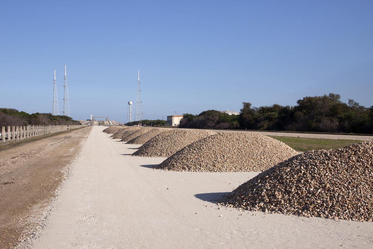 CAPE CANAVERAL, Fla. – Workers from Canaveral Construction in Mims, Fla., have removed the Alabama river rock from one side of the crawlerway near Launch Pad 39B at NASA’s Kennedy Space Center in Florida.  The crawlerway is being upgraded to improve the foundation and prepare it to support the weight of NASA’s Space Launch System, or SLS, and mobile launcher on the crawler-transporter during rollout. Workers are removing the original Alabama river rock and restoring the layer of lime rock below to its original depth of three feet. Then new river rock will be added on top. The Ground Systems Development and Operations, or GSDO, Program office at Kennedy is leading the center’s transformation to safely handle a variety of rockets and spacecraft. For more information about GSDO, visit: http:__go.nasa.gov_groundsystems.  Photo credit: NASA_Jim Grossmann