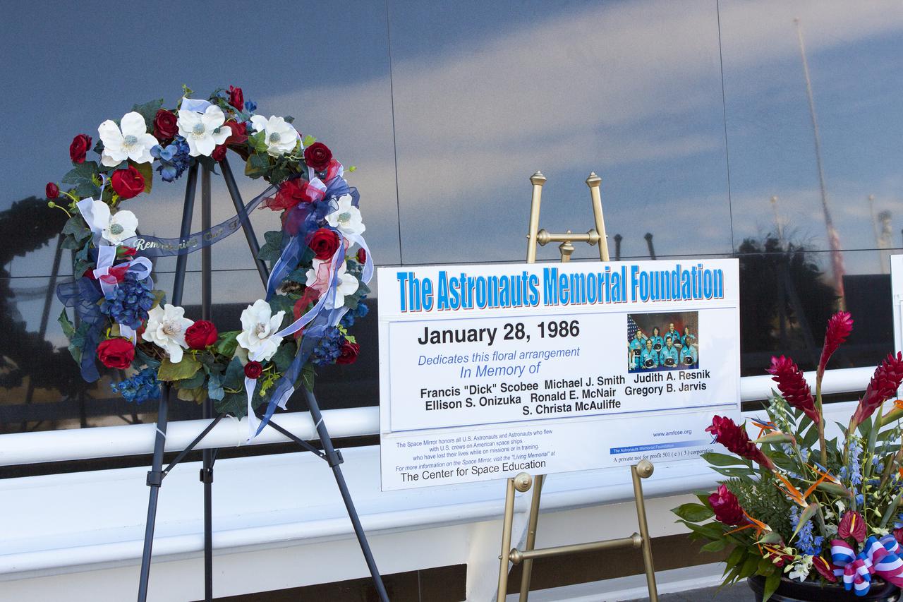 CAPE CANAVERAL, Fla. -- Kennedy Space Center Employees and guests placed wreaths and flowers at the Space Mirror Memorial at the spaceport's Visitor Complex during NASA's Day of Remembrance. The annual event took place on the 10th anniversary of the loss of the space shuttle Columbia and its crew and was hosted by the Astronauts Memorial Foundation. The ceremony also honored the astronauts of Apollo 1, who perished in 1967, and the shuttle Challenger, lost in 1986, as well as other astronauts who lost their lives while furthering the cause of exploration and discovery.   Dedicated in 1991, the names of fallen astronauts are emblazoned the monument's 4.5-foot-high-by-50-foot-wide polished black granite surface which reflects the sky and has been designated by Congress as a National Memorial. Photo credit: NASA_Jim Grossmann
