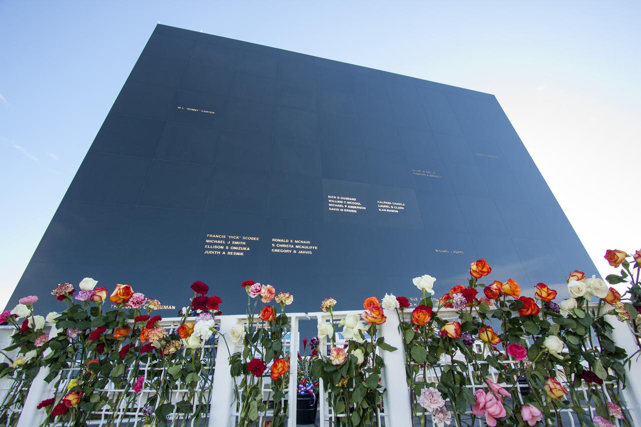 CAPE CANAVERAL, Fla. -- Kennedy Space Center Employees and guests placed wreaths and flowers at the Space Mirror Memorial at the spaceport's Visitor Complex during NASA's Day of Remembrance. The annual event took place on the 10th anniversary of the loss of the space shuttle Columbia and its crew and was hosted by the Astronauts Memorial Foundation. The ceremony also honored the astronauts of Apollo 1, who perished in 1967, and the shuttle Challenger, lost in 1986, as well as other astronauts who lost their lives while furthering the cause of exploration and discovery.   Dedicated in 1991, the names of fallen astronauts are emblazoned the monument's 4.5-foot-high-by-50-foot-wide polished black granite surface which reflects the sky and has been designated by Congress as a National Memorial. Photo credit: NASA_Jim Grossmann
