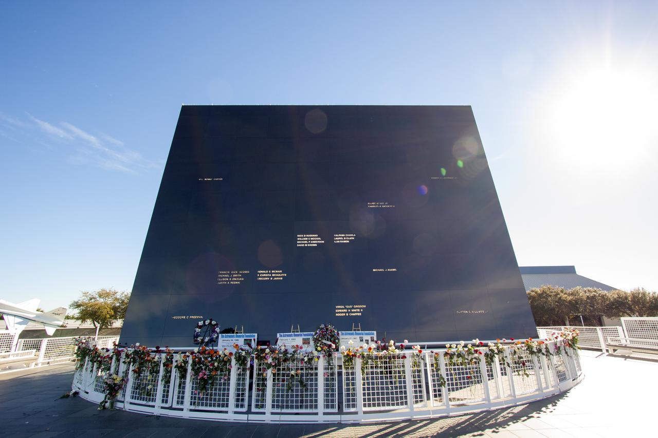 CAPE CANAVERAL, Fla. -- Kennedy Space Center Employees and guests placed wreaths and flowers at the Space Mirror Memorial at the spaceport's Visitor Complex during NASA's Day of Remembrance. The annual event took place on the 10th anniversary of the loss of the space shuttle Columbia and its crew and was hosted by the Astronauts Memorial Foundation. The ceremony also honored the astronauts of Apollo 1, who perished in 1967, and the shuttle Challenger, lost in 1986, as well as other astronauts who lost their lives while furthering the cause of exploration and discovery.   Dedicated in 1991, the names of fallen astronauts are emblazoned the monument's 4.5-foot-high-by-50-foot-wide polished black granite surface which reflects the sky and has been designated by Congress as a National Memorial. Photo credit: NASA_Jim Grossmann