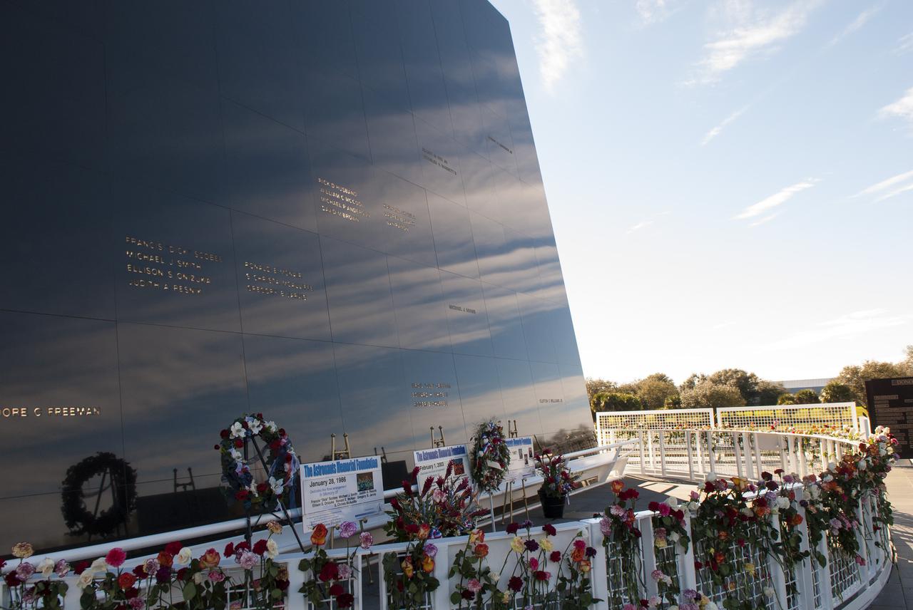 CAPE CANAVERAL, Fla. -- Kennedy Space Center Employees and guests placed wreaths and flowers at the Space Mirror Memorial at the spaceport's Visitor Complex during NASA's Day of Remembrance. The annual event took place on the 10th anniversary of the loss of the space shuttle Columbia and its crew and was hosted by the Astronauts Memorial Foundation. The ceremony also honored the astronauts of Apollo 1, who perished in 1967, and the shuttle Challenger, lost in 1986, as well as other astronauts who lost their lives while furthering the cause of exploration and discovery.   Dedicated in 1991, the names of fallen astronauts are emblazoned the monument's 4.5-foot-high-by-50-foot-wide polished black granite surface which reflects the sky and has been designated by Congress as a National Memorial. Photo credit: NASA_Tim Jacobs
