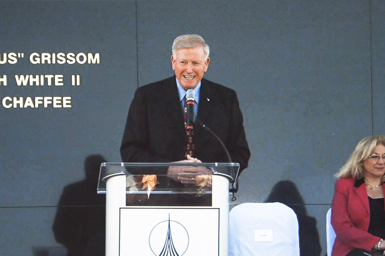 CAPE CANAVERAL, Fla. -- Former NASA astronaut Jon McBride, chairman of the Astronauts Memorial Foundation board of directors, speaks during the Day of Remembrance ceremony. Partially visible to the right is Evelyn Husband-Thompson, widow of STS-107 commander Rick Husband. Space center employees and guests gathered at the Space Mirror Memorial at the spaceport's visitor complex for the annual event which took place on the 10th anniversary of the loss of the space shuttle Columbia and its crew.   The ceremony also honored the astronauts of Apollo 1 and the shuttle Challenger. Dedicated in 1991, the names of fallen astronauts are emblazoned the Space Mirror Memorial's 4.5-foot-high-by-50-foot-wide polished black granite surface which reflects the sky and has been designated by Congress as a National Memorial. Image credit: NASA Television