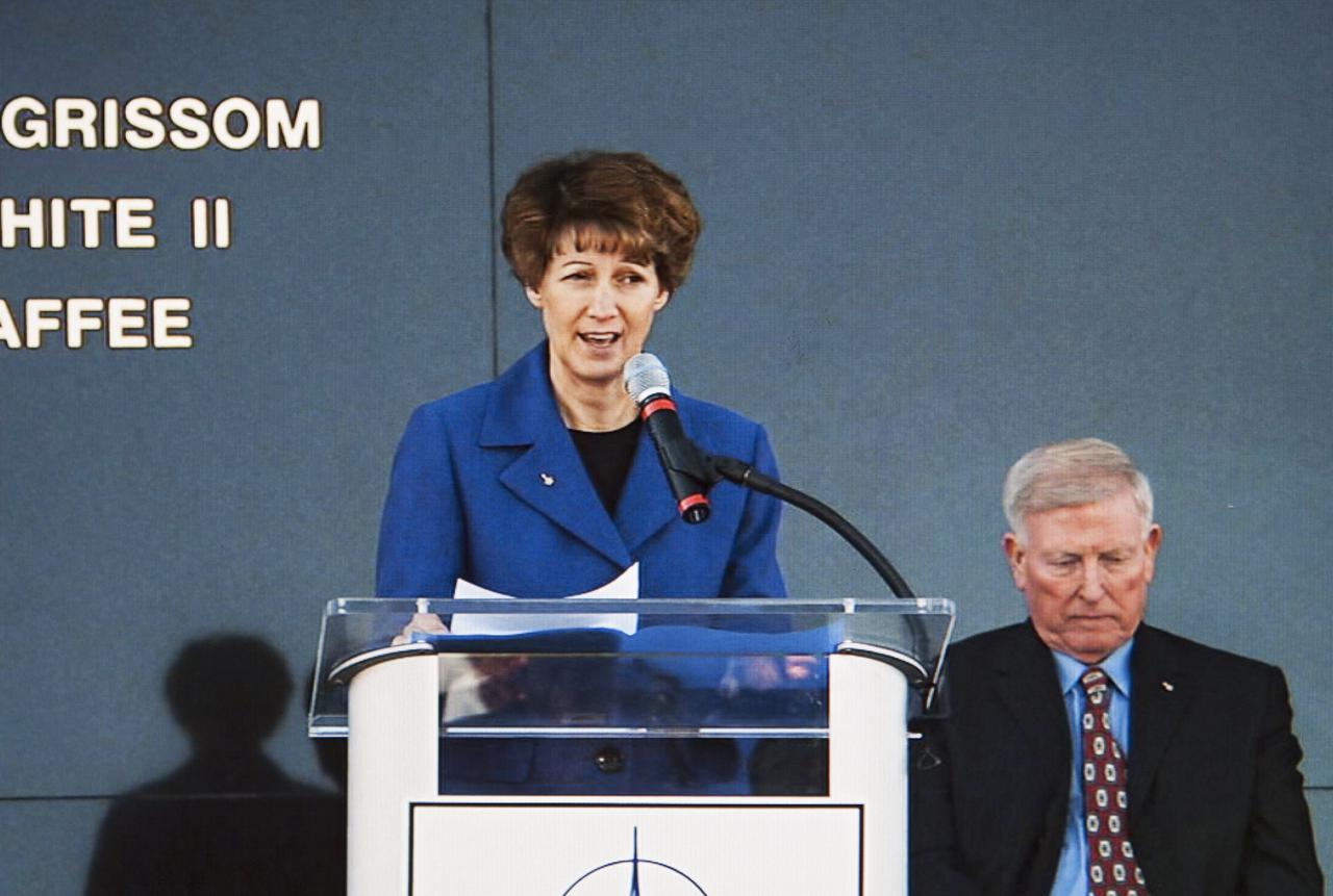 CAPE CANAVERAL, Fla. -- Former NASA astronaut Eileen Collins speaks during the Day of Remembrance ceremony. She commanded Discovery on the STS-114 mission that returned the shuttle program to flight following STS-107. Visible to the right is former NASA astronaut Jon McBride, chairman of the Astronauts Memorial Foundation board of directors. Space center employees and guests gathered at the Space Mirror Memorial at the spaceport's visitor complex for the annual event which took place on the 10th anniversary of the loss of the space shuttle Columbia and its crew.   The ceremony also honored the astronauts of Apollo 1 and the shuttle Challenger. Dedicated in 1991, the names of fallen astronauts are emblazoned the Space Mirror Memorial's 4.5-foot-high-by-50-foot-wide polished black granite surface which reflects the sky and has been designated by Congress as a National Memorial. Image credit: NASA Television