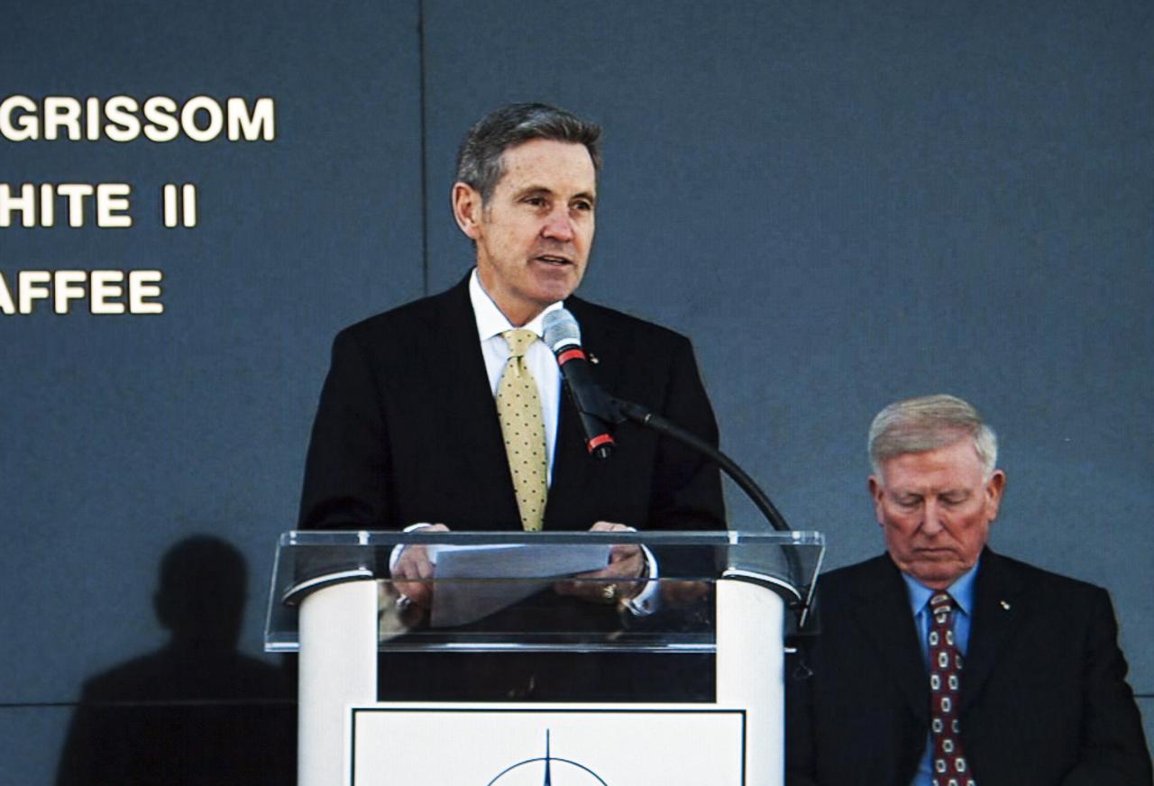 CAPE CANAVERAL, Fla. -- Kennedy Space Center director Bob Cabana, a former space shuttle commander, speaks during the Day of Remembrance ceremony. Visible to the right is former NASA astronaut Jon McBride, chairman of the Astronauts Memorial Foundation board of directors. Space center employees and guests gathered at the Space Mirror Memorial at the visitor complex for the annual event which took place on the 10th anniversary of the loss of the space shuttle Columbia and its crew.   The ceremony also honored the astronauts of Apollo 1 and the shuttle Challenger. Dedicated in 1991, the names of fallen astronauts are emblazoned the Space Mirror Memorial's 4.5-foot-high-by-50-foot-wide polished black granite surface which reflects the sky and has been designated by Congress as a National Memorial. Image credit: NASA Television