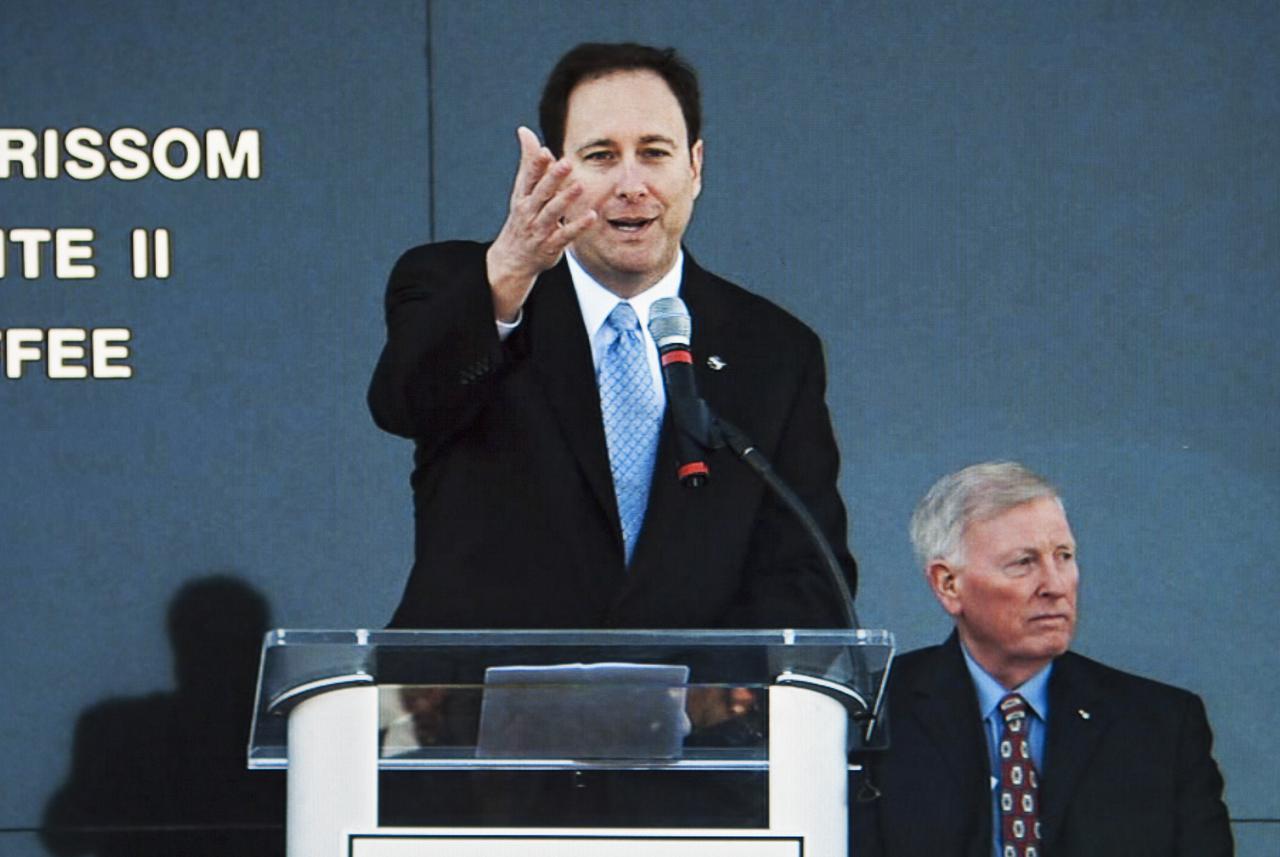 CAPE CANAVERAL, Fla. -- NASA Associate Administrator Robert Lightfoot speaks during the Day of Remembrance ceremony. Visible to the right is former NASA astronaut Jon McBride, chairman of the Astronauts Memorial Foundation board of directors. Space center employees and guests gathered at the Space Mirror Memorial at the spaceport's visitor complex for the annual event which took place on the 10th anniversary of the loss of the space shuttle Columbia and its crew.   The ceremony also honored the astronauts of Apollo 1 and the shuttle Challenger. Dedicated in 1991, the names of fallen astronauts are emblazoned the Space Mirror Memorial's 4.5-foot-high-by-50-foot-wide polished black granite surface which reflects the sky and has been designated by Congress as a National Memorial. Image credit: NASA Television