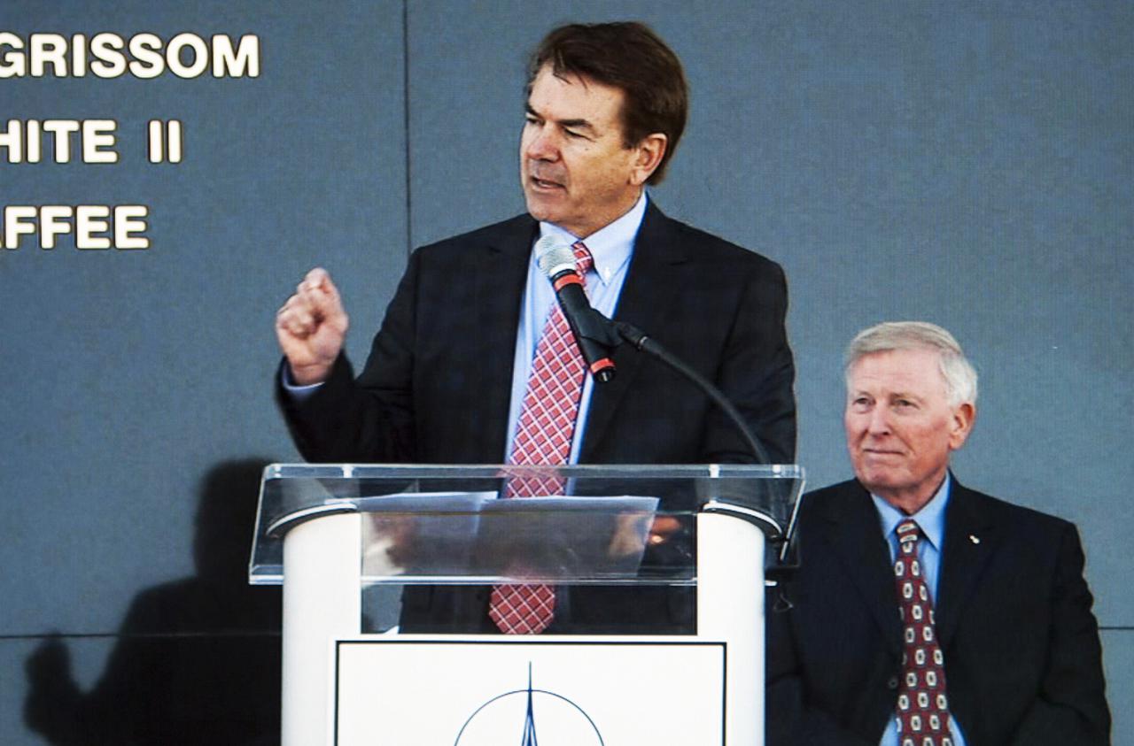 CAPE CANAVERAL, Fla. -- State Sen. Thad Altman, president and chief executive officer of the Astronauts Memorial Foundation, speaks during the Day of Remembrance ceremony. Visible to the right is former NASA astronaut Jon McBride, chairman of the Astronauts Memorial Foundation board of directors. Space center Employees and guests gathered at the Space Mirror Memorial at the visitor complex for the annual event which took place on the 10th anniversary of the loss of the space shuttle Columbia and its crew.   The ceremony also honored the astronauts of Apollo 1 and the shuttle Challenger. Dedicated in 1991, the names of fallen astronauts are emblazoned the Space Mirror Memorial's 4.5-foot-high-by-50-foot-wide polished black granite surface which reflects the sky and has been designated by Congress as a National Memorial. Image credit: NASA Television