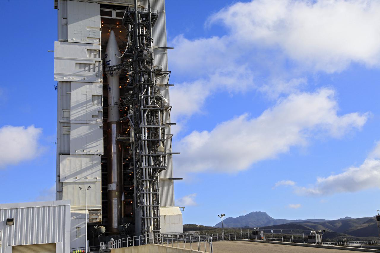 VANDENBERG AFB, Calif. -- At Vandenberg Air Force Base, Calif., NASA's Landsat Data Continuity Mission, or LDCM, satellite is mounted atop a United Launch Alliance Atlas V rocket in the gantry at Space Launch Complex 3E. The Landsat Data Continuity Mission LDCM is the future of Landsat satellites. It will continue to obtain valuable data and imagery to be used in agriculture, education, business, science, and government. The Landsat Program provides repetitive acquisition of high resolution multispectral data of the Earth's surface on a global basis. The data from the Landsat spacecraft constitute the longest record of the Earth's continental surfaces as seen from space. It is a record unmatched in quality, detail, coverage, and value. Liftoff is planned for Feb. 11, 2013 aboard a United Launch Alliance Atlas V rocket. For more information, visit: http:__www.nasa.gov_mission_pages_landsat_main_index.html Photo credit: NASA_Kim Shiflett
