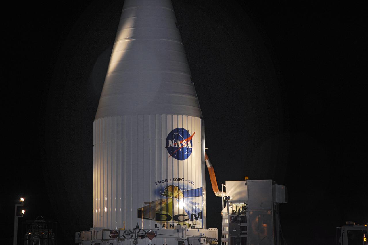 VANDENBERG AFB, Calif. -- The payload fairing containing the Landsat Data Continuity Mission, or LDCM, spacecraft is mounted atop a United Launch Alliance Atlas V rocket at Space Launch Complex-3E at Vandenberg Air Force Base, Calif. The Landsat Data Continuity Mission LDCM is the future of Landsat satellites. It will continue to obtain valuable data and imagery to be used in agriculture, education, business, science, and government. The Landsat Program provides repetitive acquisition of high resolution multispectral data of the Earth's surface on a global basis. The data from the Landsat spacecraft constitute the longest record of the Earth's continental surfaces as seen from space. It is a record unmatched in quality, detail, coverage, and value. Liftoff is planned for Feb. 11, 2013 aboard a United Launch Alliance Atlas V rocket. For more information, visit: http:__www.nasa.gov_mission_pages_landsat_main_index.html Photo credit: NASA
