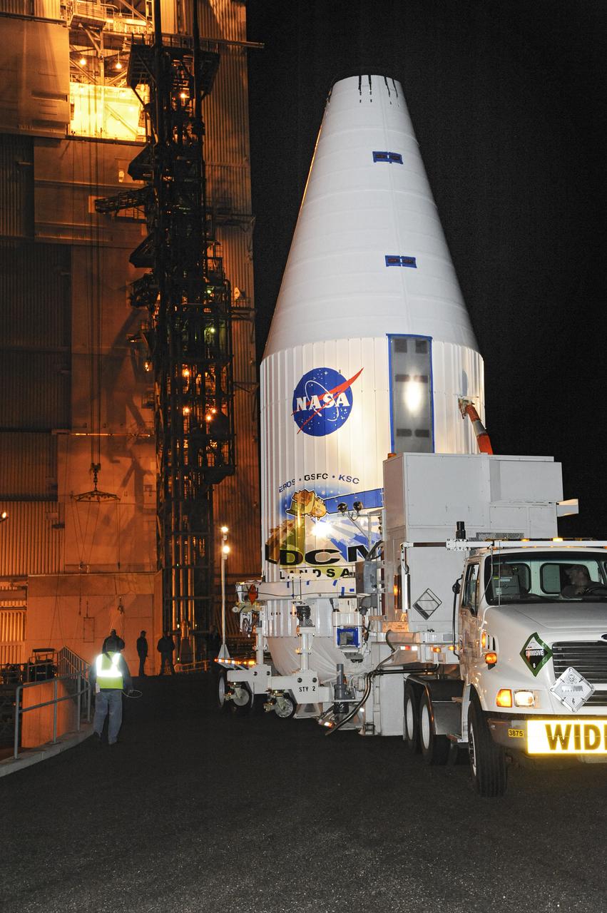 VANDENBERG AFB, Calif. -- The payload fairing containing the Landsat Data Continuity Mission, or LDCM, spacecraft arrives at Space Launch Complex-3E at Vandenberg Air Force Base, Calif. where it will be hoisted atop a United Launch Alliance Atlas V for launch.    The Landsat Data Continuity Mission LDCM is the future of Landsat satellites. It will continue to obtain valuable data and imagery to be used in agriculture, education, business, science, and government. The Landsat Program provides repetitive acquisition of high resolution multispectral data of the Earth's surface on a global basis. The data from the Landsat spacecraft constitute the longest record of the Earth's continental surfaces as seen from space. It is a record unmatched in quality, detail, coverage, and value. Liftoff is planned for Feb. 11, 2013 aboard a United Launch Alliance Atlas V rocket. For more information, visit: http:__www.nasa.gov_mission_pages_landsat_main_index.html Photo credit: NASA